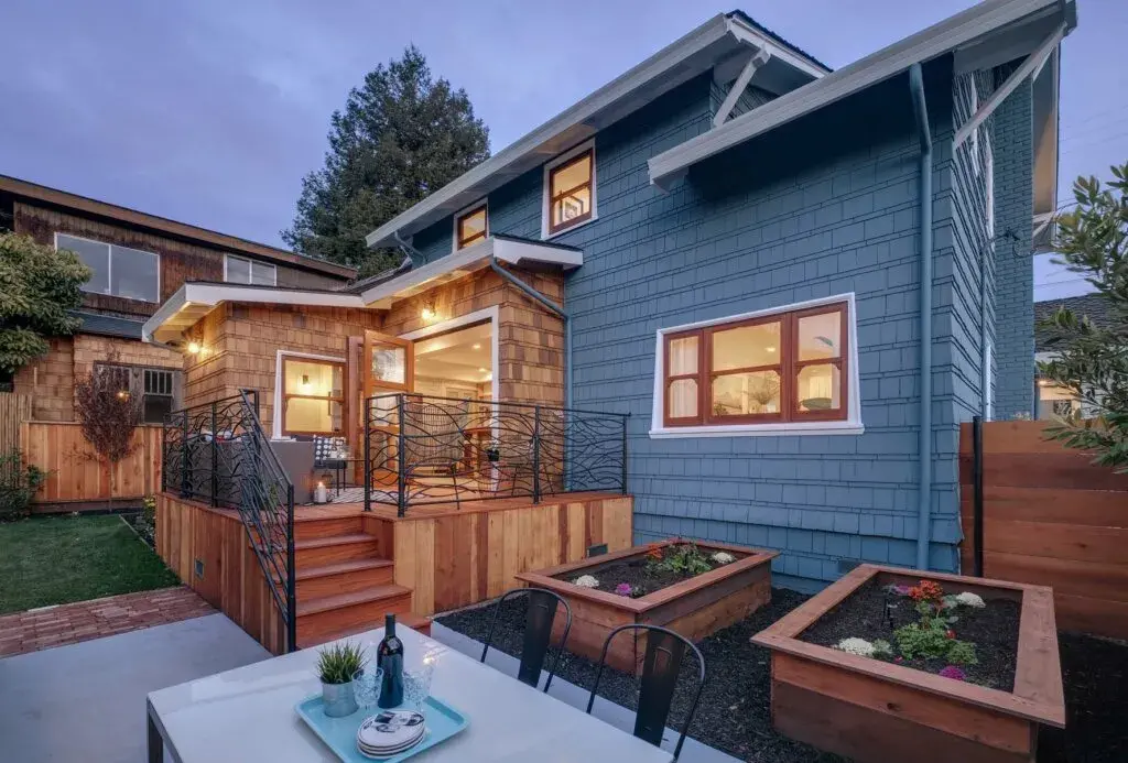 Beautifully designed outdoor space featuring a dining table and chairs, enhanced by ambient lighting for a cozy and inviting atmosphere