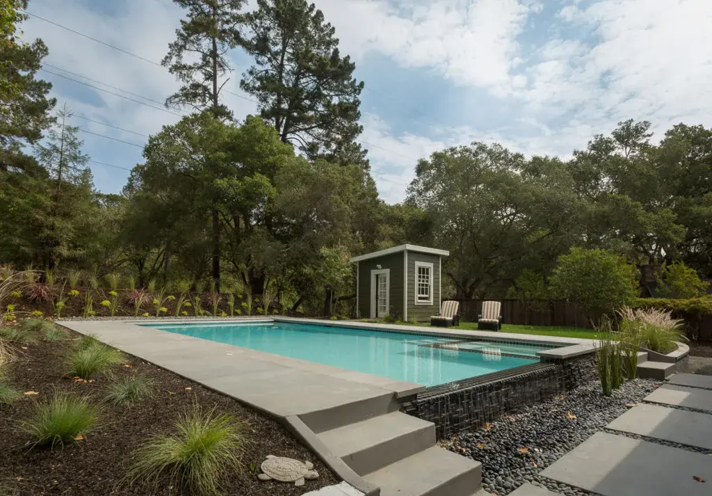 Stunning outdoor swimming pool featuring crystal-clear water and surrounded by luxurious landscaping, offering a perfect blend of relaxation and elegance